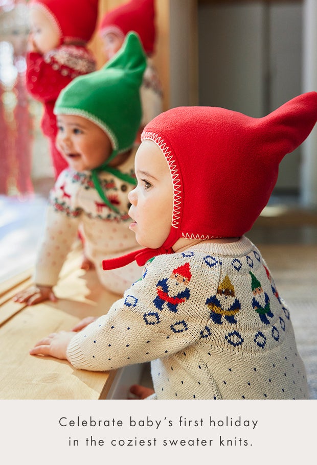 babies looking out the window wearing sweater knit clothes